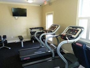 Jacksonville apartment for rent - a workout room with a treadmill and a tv