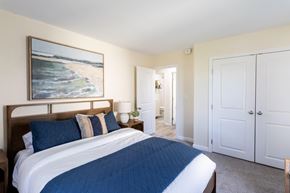 Middletown apartment for rent - A bedroom with a large bed and a painting on the wall.