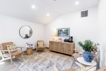 Middleboro apartment for rent - A living room with a grey rug and a wooden cabinet.