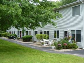 Kingston apartment for rent - a white house with a yard and a patio