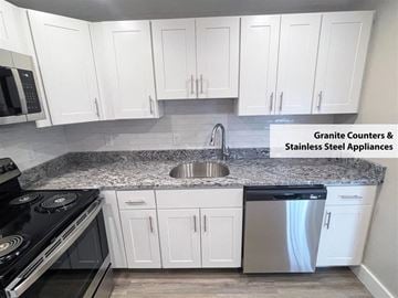 Middletown apartment for rent - a kitchen with white cabinets and stainless steel appliances