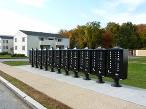 New London apartment for rent - a line of mailboxes on a sidewalk in front of a house