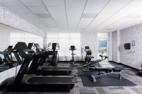 London apartment for rent - A gym with treadmills, exercise bikes, and other equipment at 1600 Hyde Park Village Apartments, London