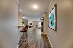 London apartment for rent - a kitchen and living room with hardwood flooring and a painting on the wall