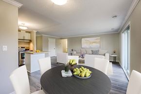 London apartment for rent - a dining area with a table and chairs and a kitchen in the background