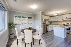 London apartment for rent - a dining area with a table and chairs and a kitchen in the background