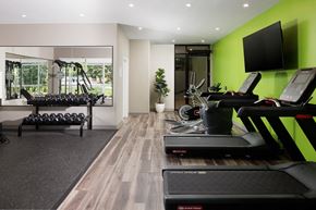 London apartment for rent - A gym with treadmills, weights, and exercise equipment.