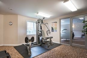 London apartment for rent - a fitness center with a treadmills and other exercise equipment