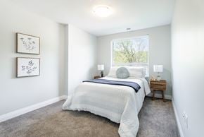 London apartment for rent - A bedroom with a large bed and two pictures on the wall.