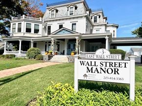 Norwalk apartment for rent - a large white house with a sign that reads wall street manor
