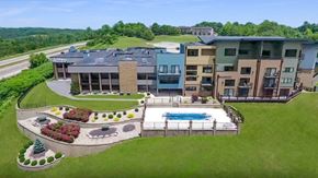Collinsville apartment for rent - a rendering of a building with a pool and a yard