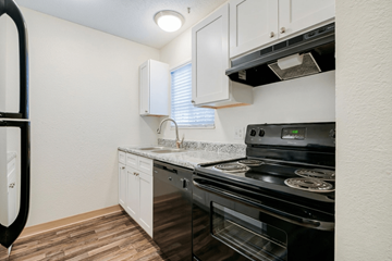 Fairview Heights apartment for rent - A kitchen with a black stove top oven and white cabinets.