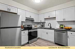 Edwardsville apartment for rent - A kitchen with white cabinets and a black fridge.