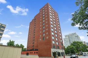 St. Louis apartment for rent - a tall brick building with a blue sky in the background