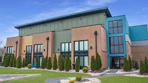Collinsville apartment for rent - the front of a building with windows and a green roof