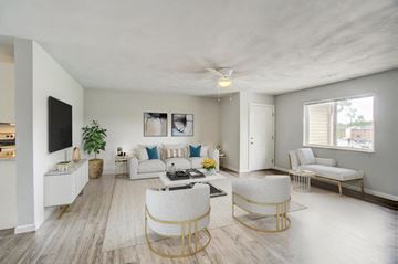 O'fallon apartment for rent - a living room with a couch and chairs and a tv