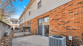 Dupo townhouse for rent - A brick wall with a sliding glass door and a wall-mounted air conditioning unit.