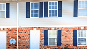 Dupo townhouse for rent - A red brick house with white doors and windows.