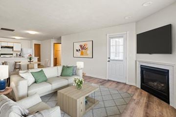 Shiloh apartment for rent - A living room with a white couch and a fireplace.