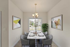 Carbondale apartment for rent - A dining room with a table set for two and a view of a building outside the window.