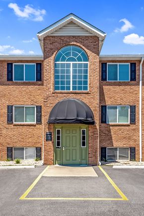O'fallon apartment for rent - the front of a brick building with a green door and an awning