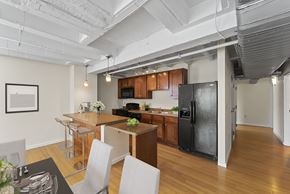 St. Louis apartment for rent - an open kitchen and dining area with a black refrigerator