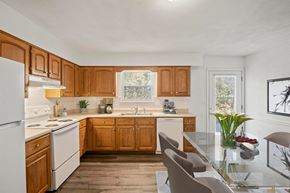 O'fallon apartment for rent - a kitchen with wooden cabinets and white appliances