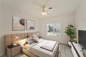Carbondale apartment for rent - A bedroom with a large bed and a ceiling fan.