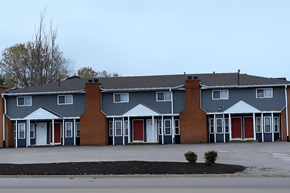 Shiloh apartment for rent - A row of houses with grey and brown exteriors.