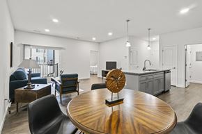 Barnhart apartment for rent - A modern kitchen with a wooden table and chairs.