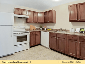 Greenville apartment for rent - a kitchen with white appliances and brown cabinets