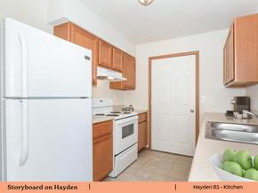 Mascoutah apartment for rent - a kitchen with white appliances and wooden cabinets