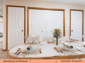 Swansea apartment for rent - a dining room with white doors and a table with plates and silverware