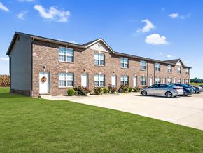 Lebanon apartment for rent - A modern two-story brick house with a garage and a car parked in front.
