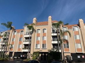 Los Angeles apartment for rent - The castle heights apartment building with a balcony and a black gate in front.