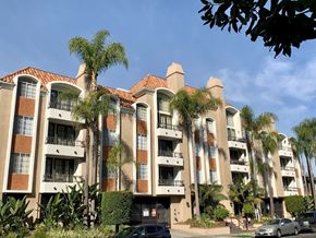 Los Angeles apartment for rent - The castle heights apartment building with a red tile roof and balconies.