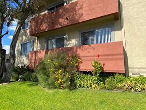 Redondo Beach apartment for rent - A building with a red awning and a green lawn in front.