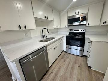 Redondo Beach apartment for rent - A kitchen with white cabinets and a black oven.