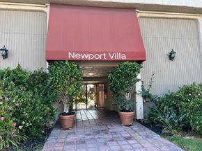 Newport Beach apartment for rent - the entrance to the building with a red awning