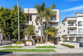 Los Angeles apartment for rent - Image of the 9025 Alcott Apartment building with a well-maintained lawn and trees.