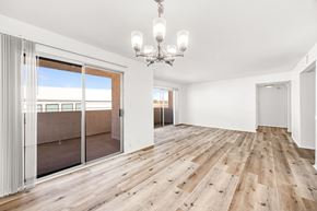 Los Angeles apartment for rent - a living room with a sliding glass door and a chandelier
