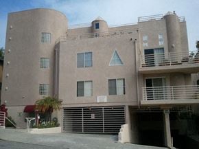 West Hollywood apartment for rent - A large building with a balcony on the second floor.