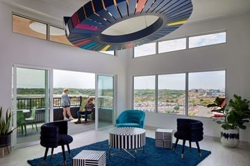 Omaha apartment for rent - a living room with blue chairs and a blue rug