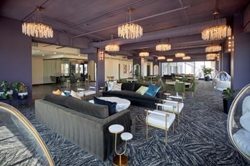 Omaha apartment for rent - A modern living room with a grey sofa and gold chairs.