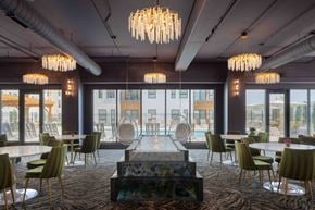 Omaha apartment for rent - A modern dining room with a long table and chairs.