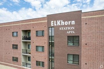 Elkhorn apartment for rent - A red brick building with the words "Elkhorn Station Apts." on the front.