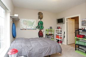 Elkhorn apartment for rent - A bedroom with a bed, a TV, and a map on the wall.