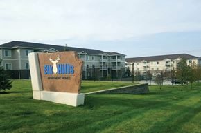 Elkhorn apartment for rent - A sign for Eco Hills Apartment Homes sits in front of apartment buildings.