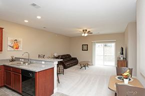 Elkhorn apartment for rent - A kitchen with a sink, stove, and a dining table with chairs.