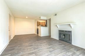 Mobile apartment for rent - Living room with fireplace and wood floors at Ashford Place Mobile AL